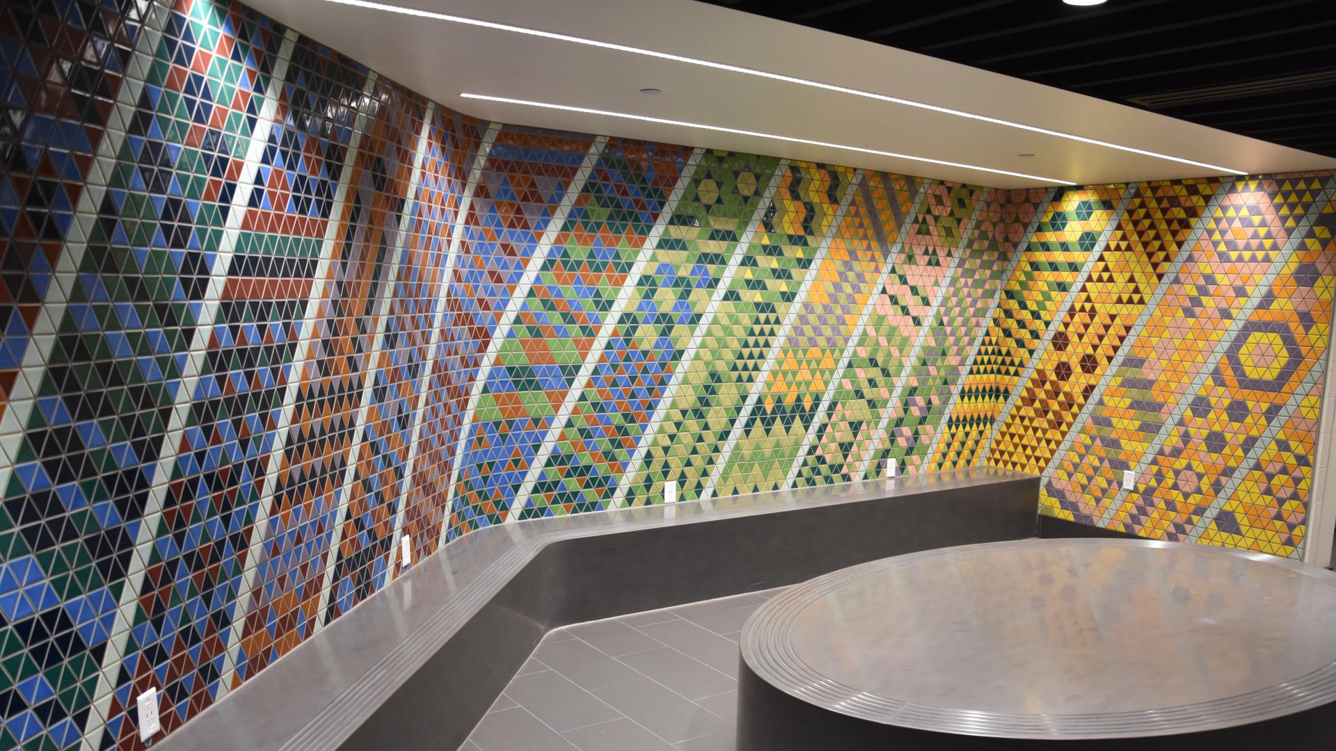 A colourful moasic made of triangular tiles greets users of the Leisure Centre in the waiting area.