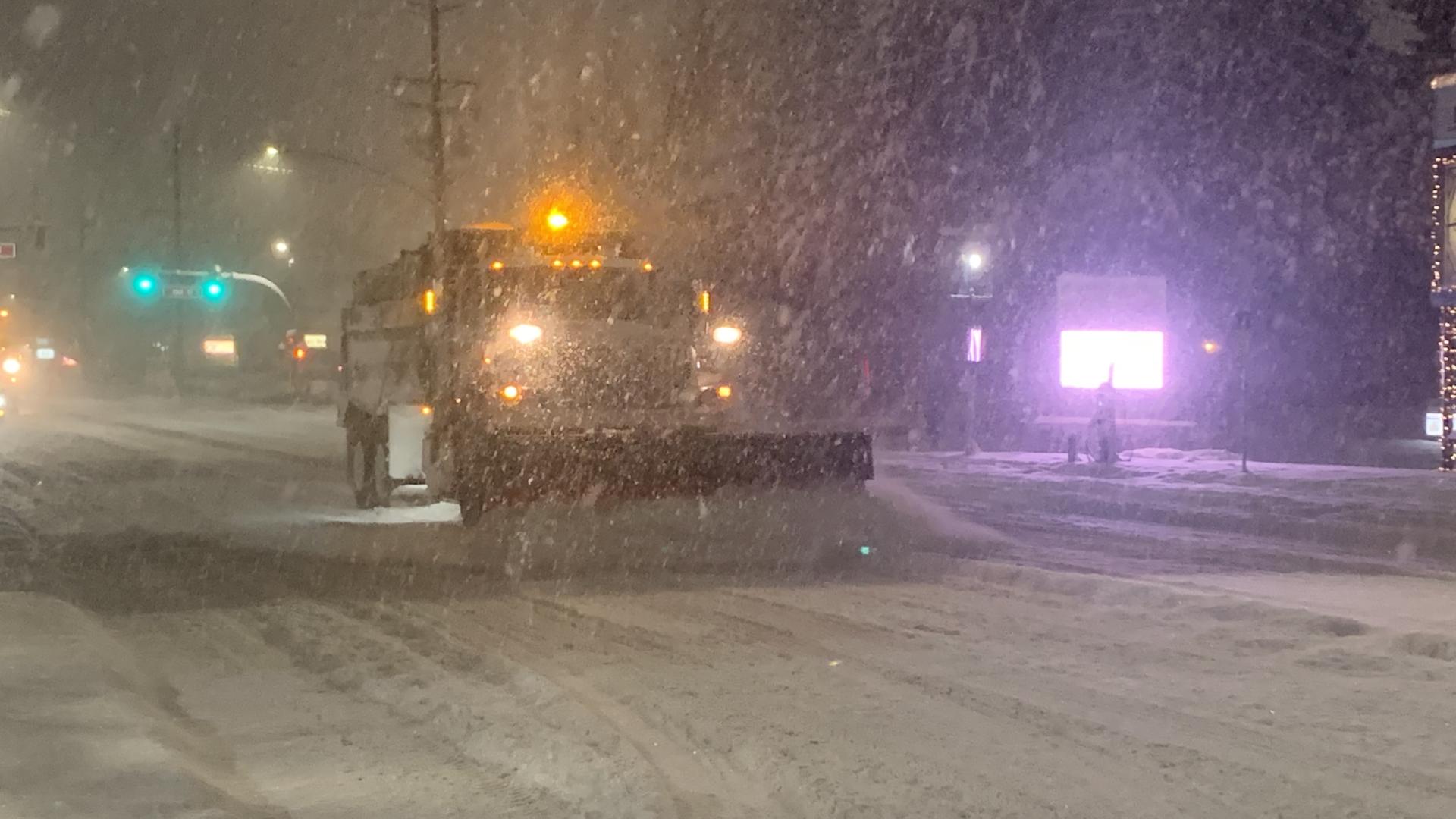 snow plow driving in a snow storm