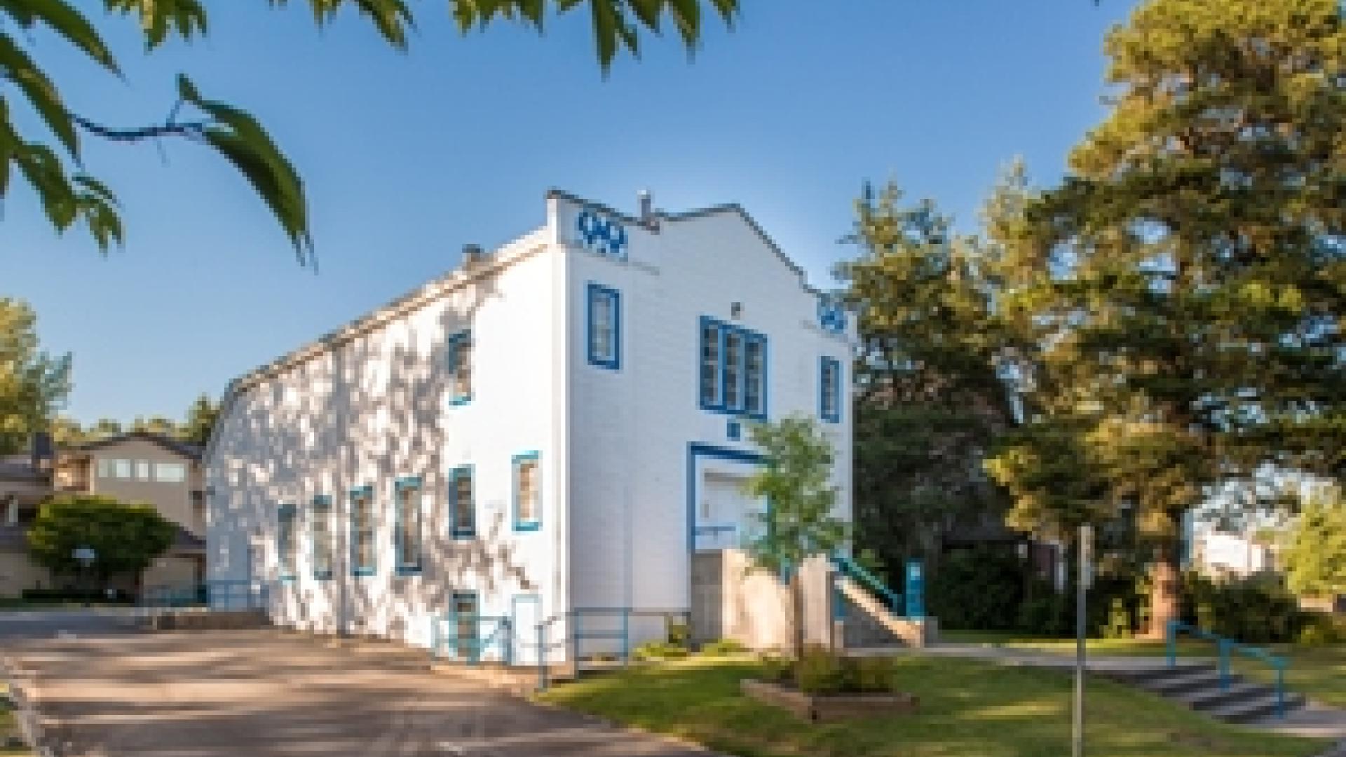 Exterior of Prince David Masonic Hall. The building is a tall white, wooden building. 