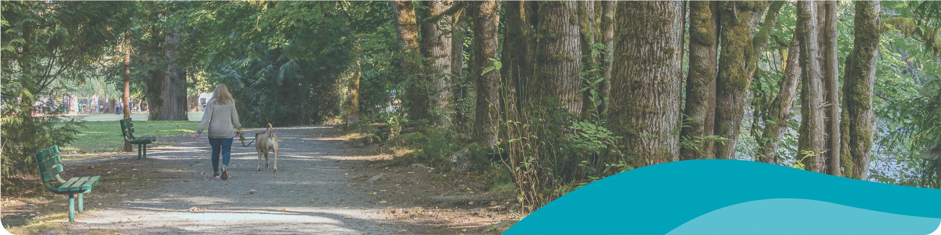 woman walking the dog in a park