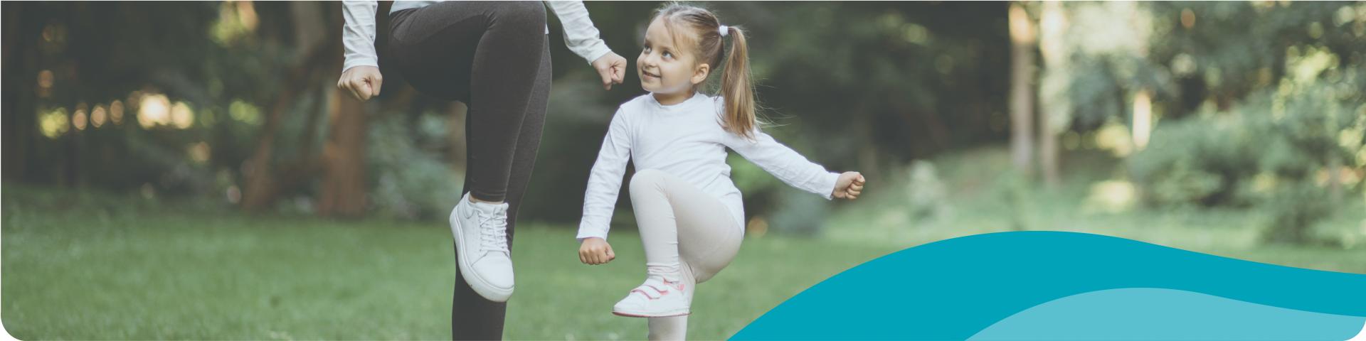 little girl exercising with her mom