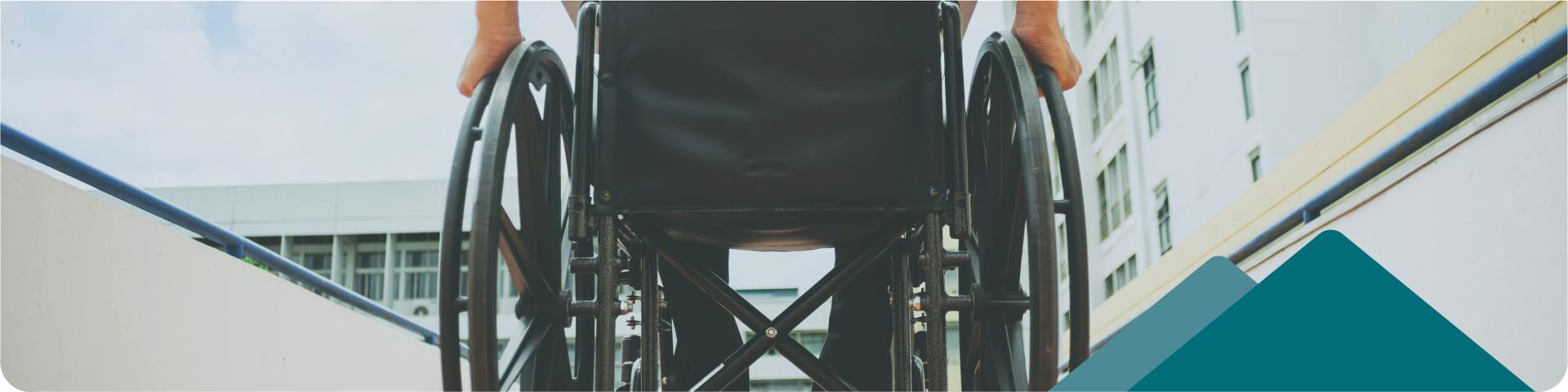 Wheelchair User Travelling Up A Ramp