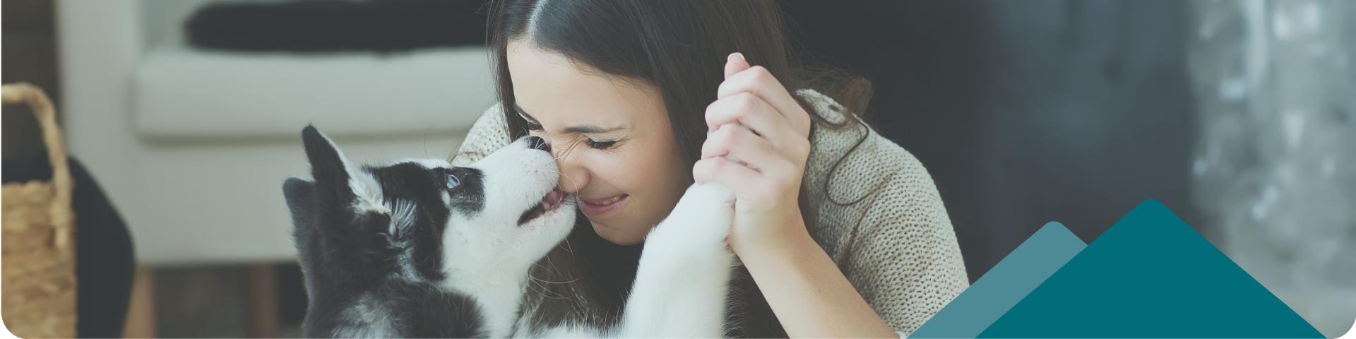 woman cuddling with her dog 