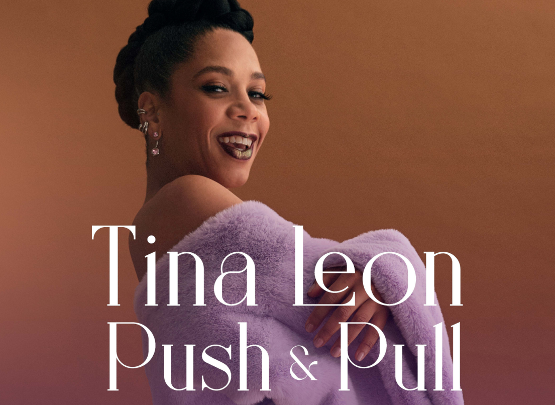 The cover of Tina Leon's new album "Push and Pull", where Tina smiles at the camera with her hair up in an off-the-shoulder purple sweater against a brown background.